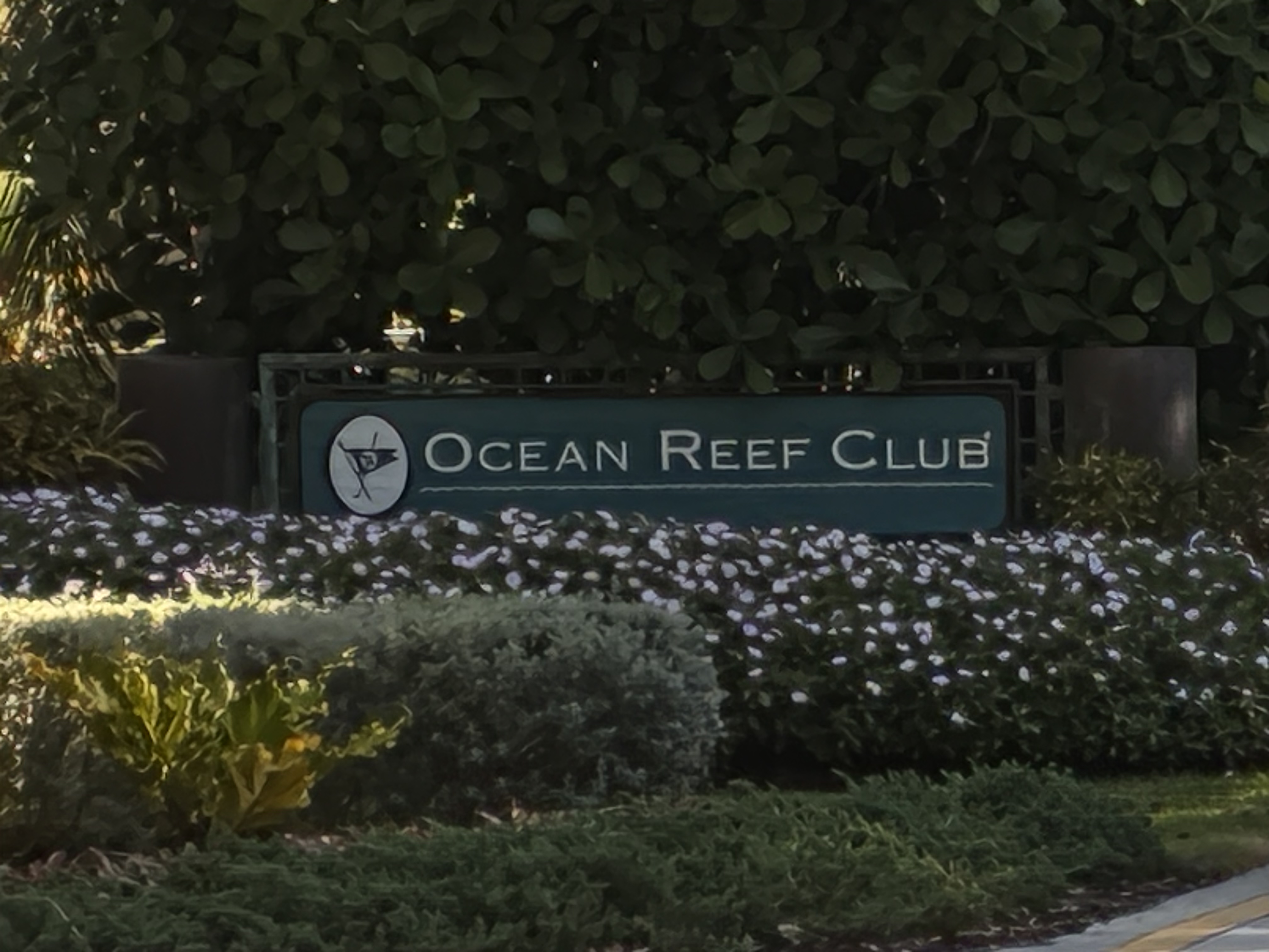 Ocean Reef Club entrance sign surrounded by tropical landscaping